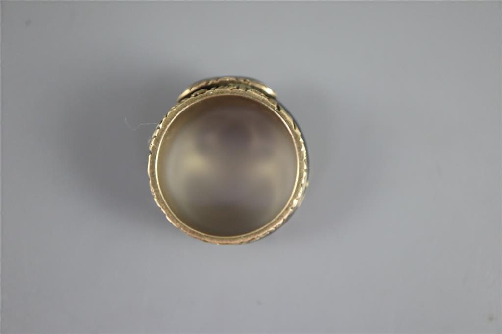 A George III gold and black enamel memorial ring with hairwork panel and a matching brooch,